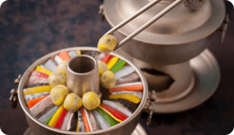 Sinseollo made of various ingredients and holding with chopsticks